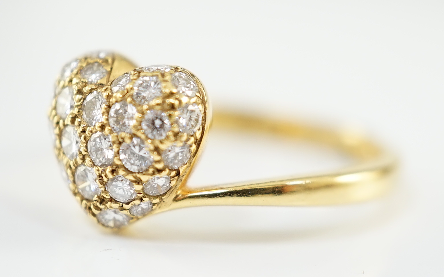 A modern Cartier 18ct gold and pave set diamond heart shaped ring